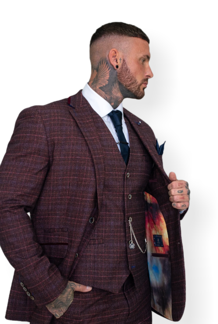 Man wearing a stylish burgundy three-piece suit with plaid pattern, showcasing a colorful inner lining. Perfect for formal and fashionable events.