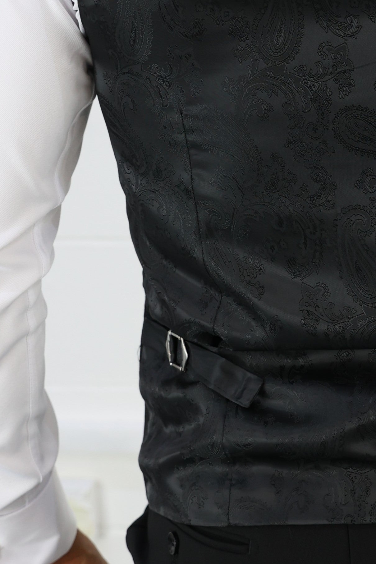 Close-up of the back of the Suitbae black pinstripe double-breasted waistcoat, featuring a paisley-patterned silk fabric with an adjustable buckle for a perfect fit; available in skinny fit, slim fit, tailored fit, plus size, larger men's, and big & tall sizes.