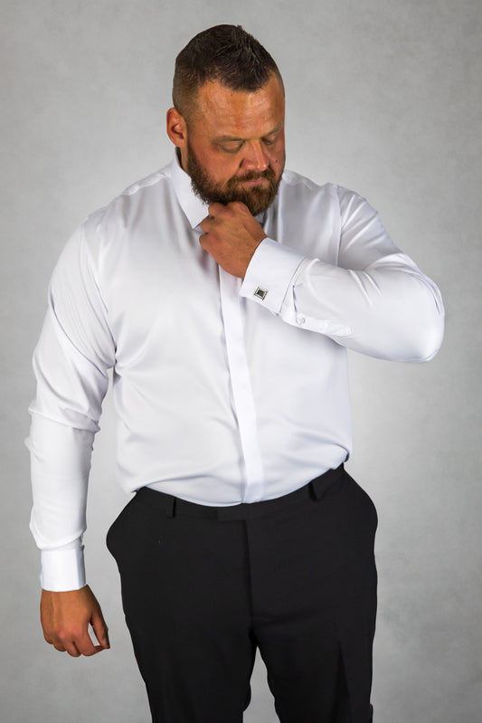 Man wearing a white long-sleeve dress shirt paired with black trousers, featuring cufflinks and a modern tailored fit. The formal shirt is ideal for business, weddings, and special occasions, offering a sharp, polished look.