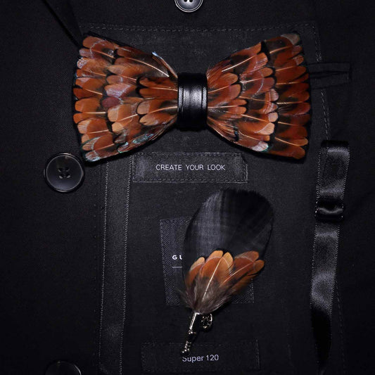 close up of brown feather bowtie and matching lapel pin