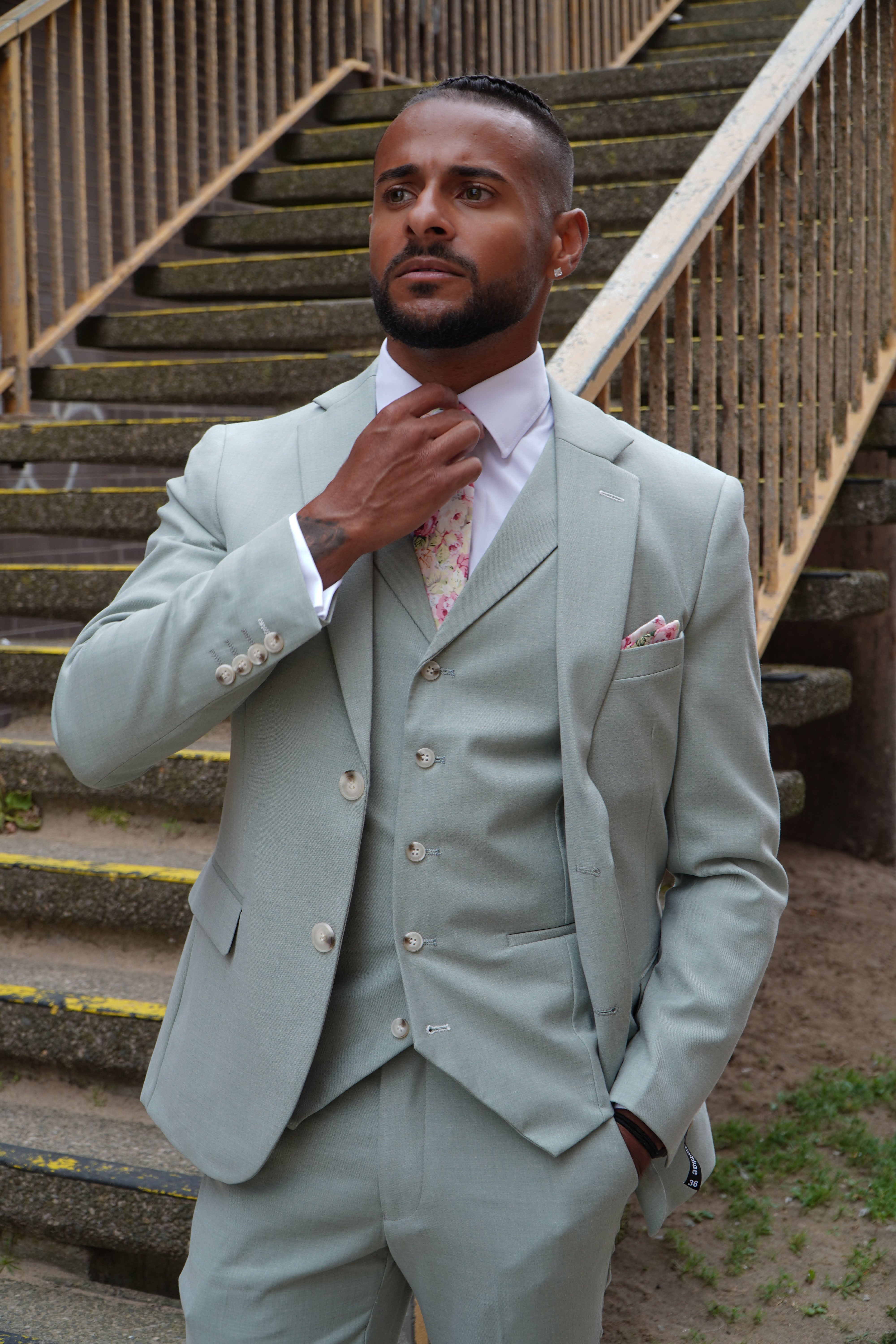 Model wearing the SUITBAE Callum Sage Three-Piece Suit — light sage colour, perfect for spring weddings and events.