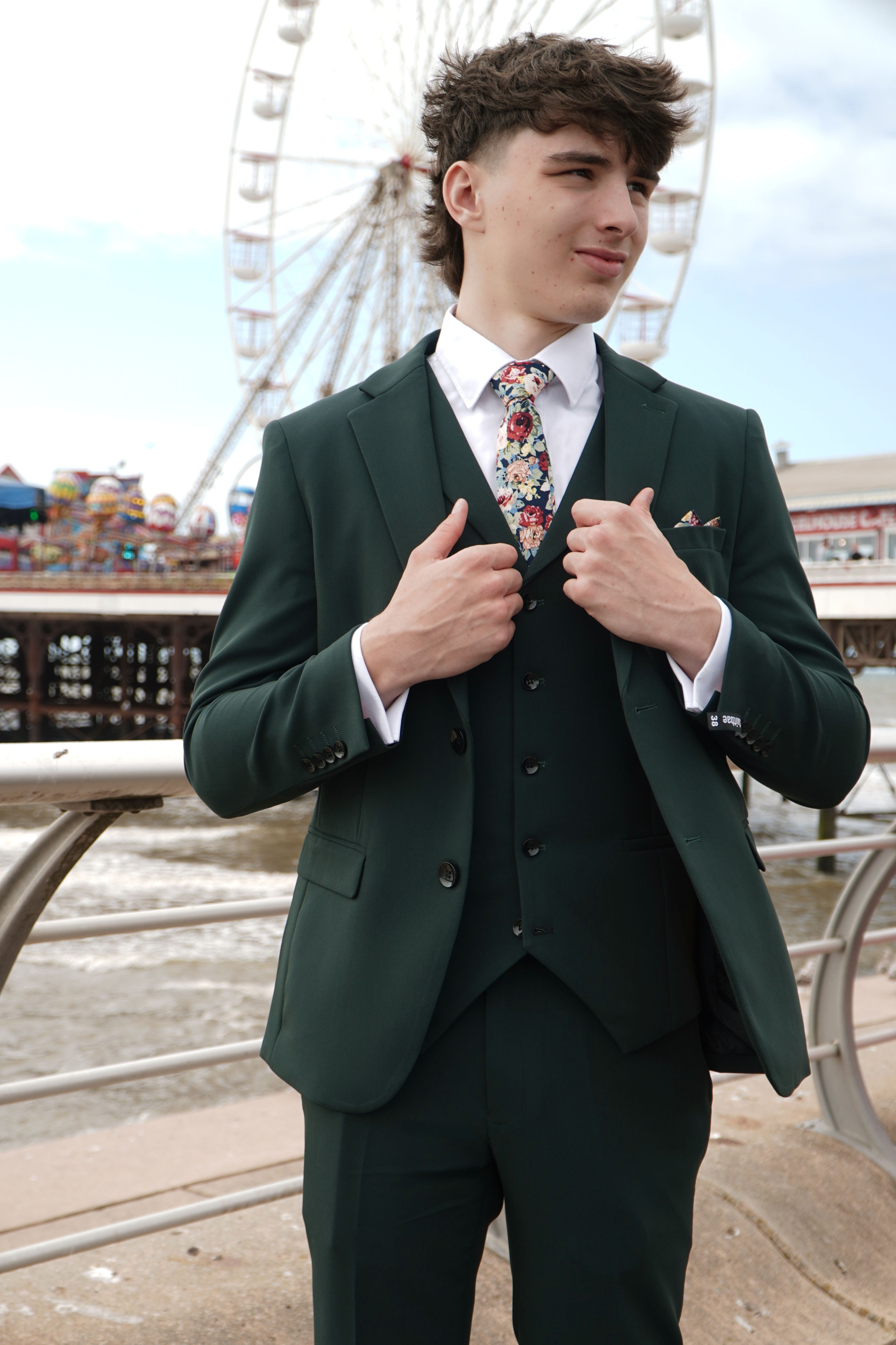 Model wearing the SUITBAE Archie Green Three-Piece Suit — deep green tone for spring weddings and race days.