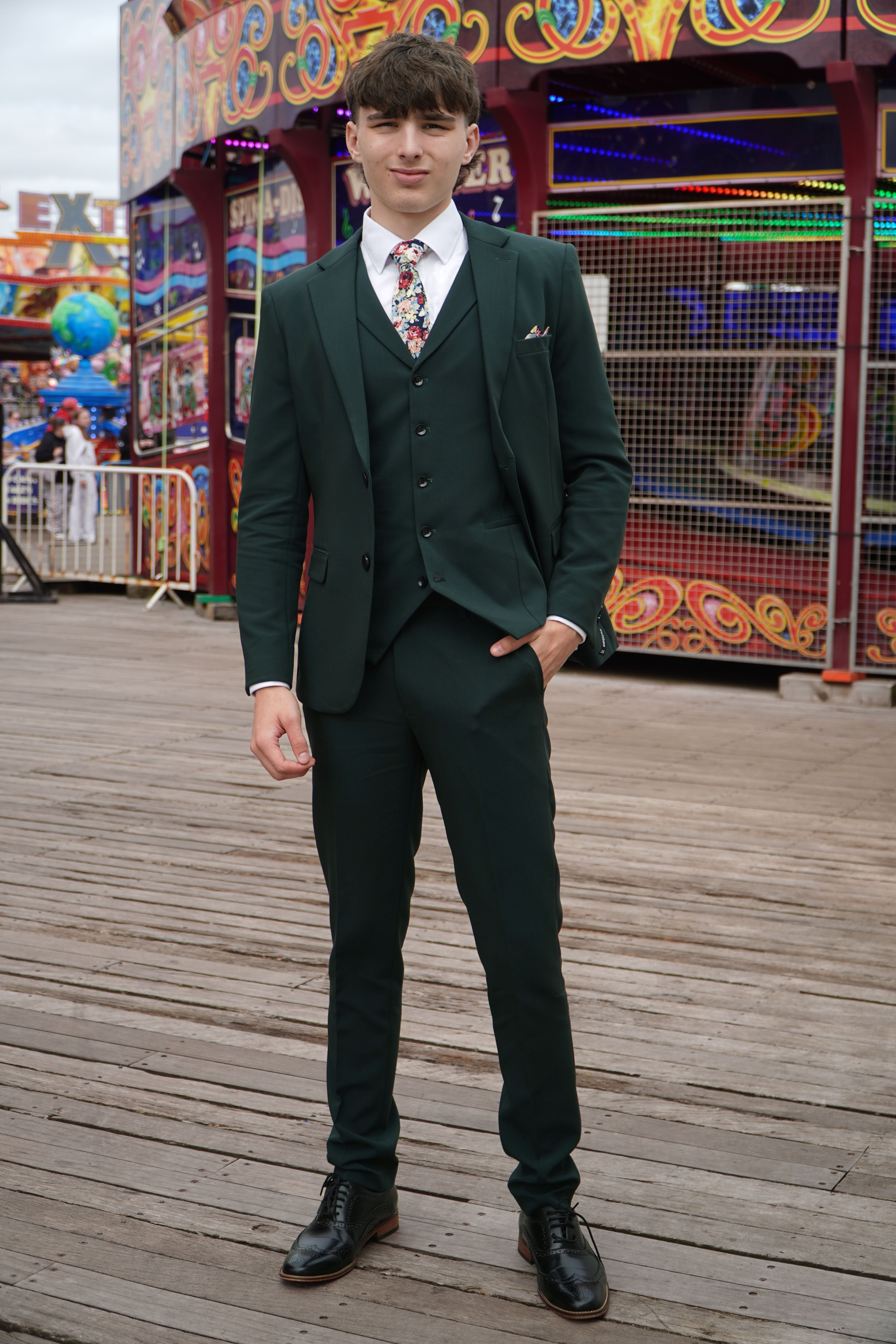 Model wearing the Archie Green Three-Piece Suit by SUITBAE — forest green colourway, ideal for autumn weddings and events.