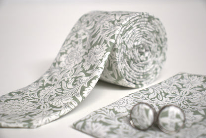 Detailed view of sage green and white floral tie fabric, elegant men’s accessory for weddings, races and summer proms