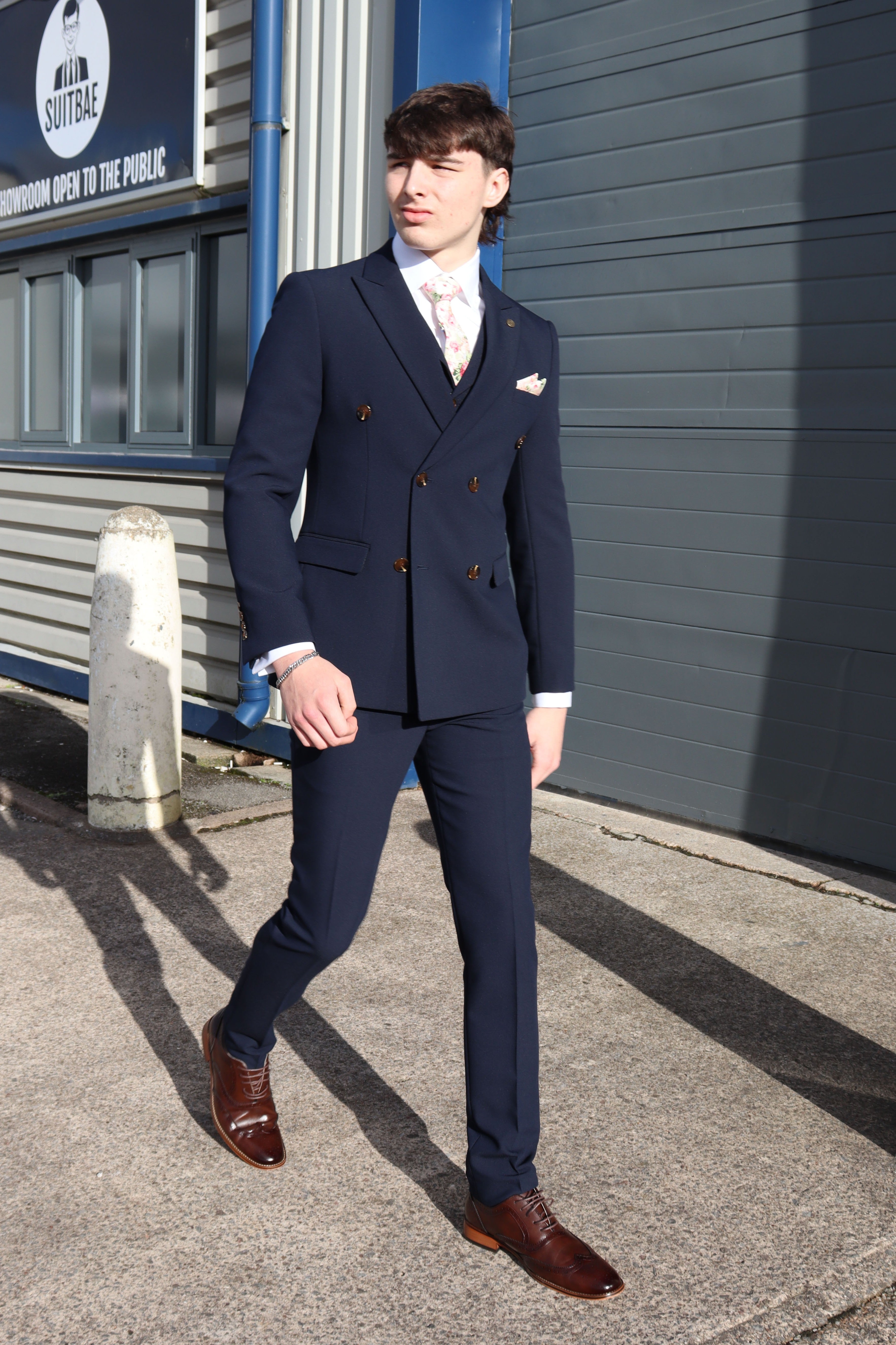 Model wearing the SUITBAE Lawrence Navy Double Breasted Three-Piece Suit — rich navy colour, perfect for spring weddings and events.