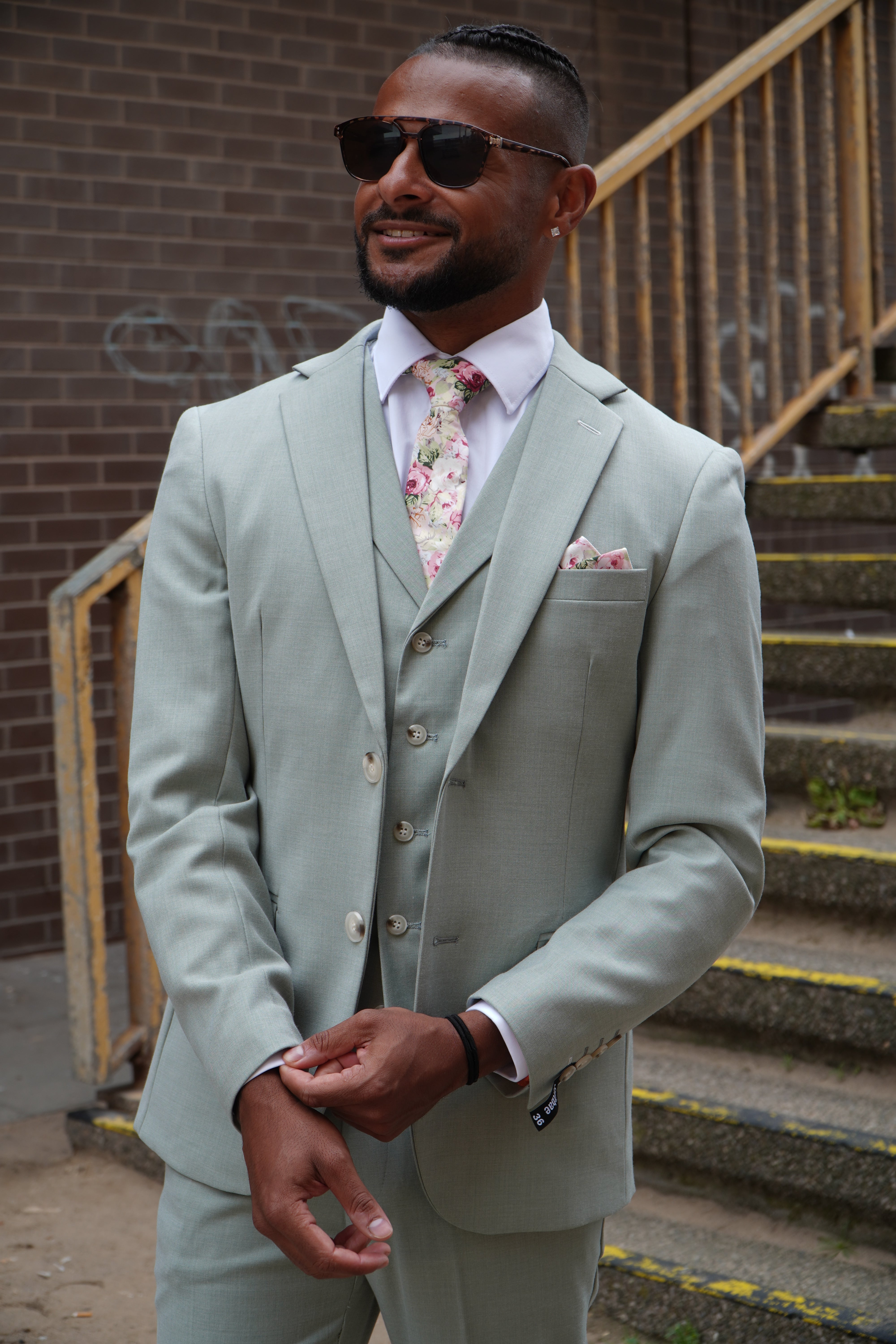 Model wearing the SUITBAE Callum Sage Three-Piece Suit — soft green tone for spring weddings and race days.