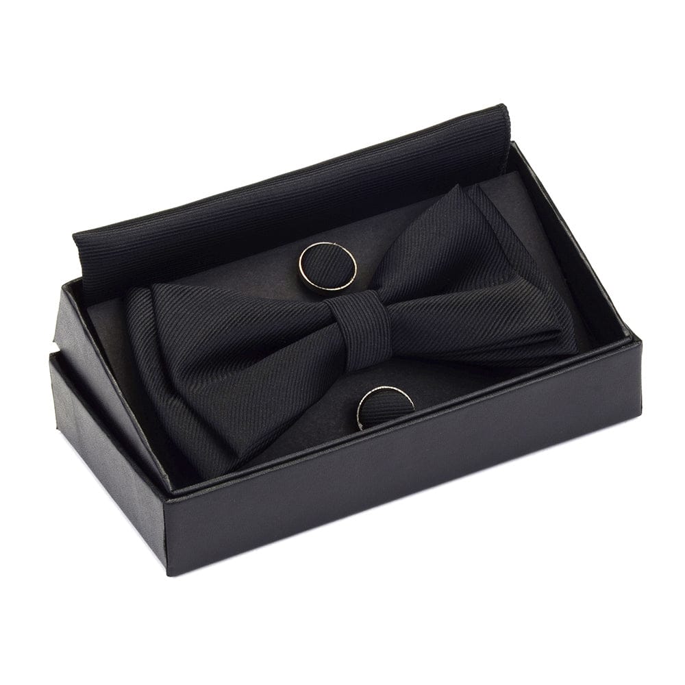 close up of fabric black bowtie with matching cufflinks and pocket square in a box